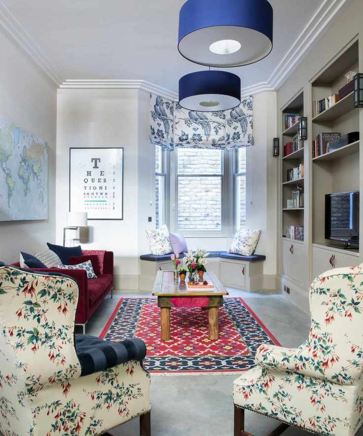 A vibrant living room filled with colorful decor and a large bay window.