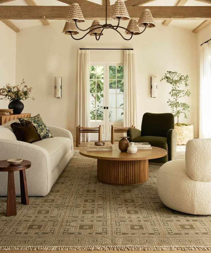 neutral living room by lulu and georgia with a large patterned rug and curved furniture