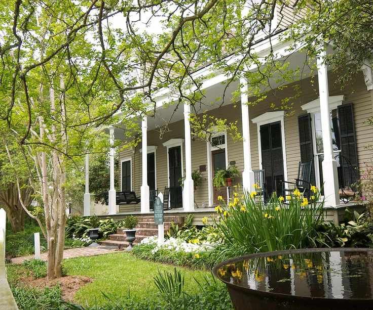View of a front yard with a house and a porch in the background
