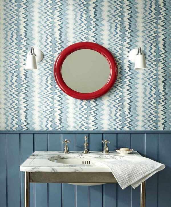 Red mirror in a blue bathroom