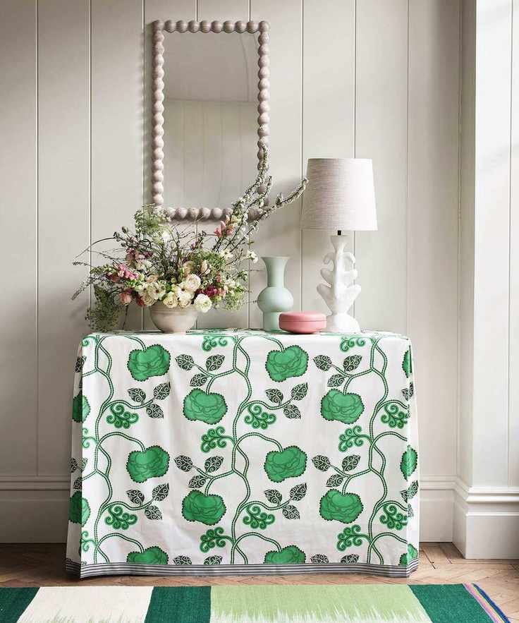 A console table with a table lamp and decorative items
