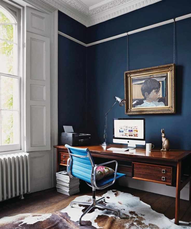 A home office with navy walls.