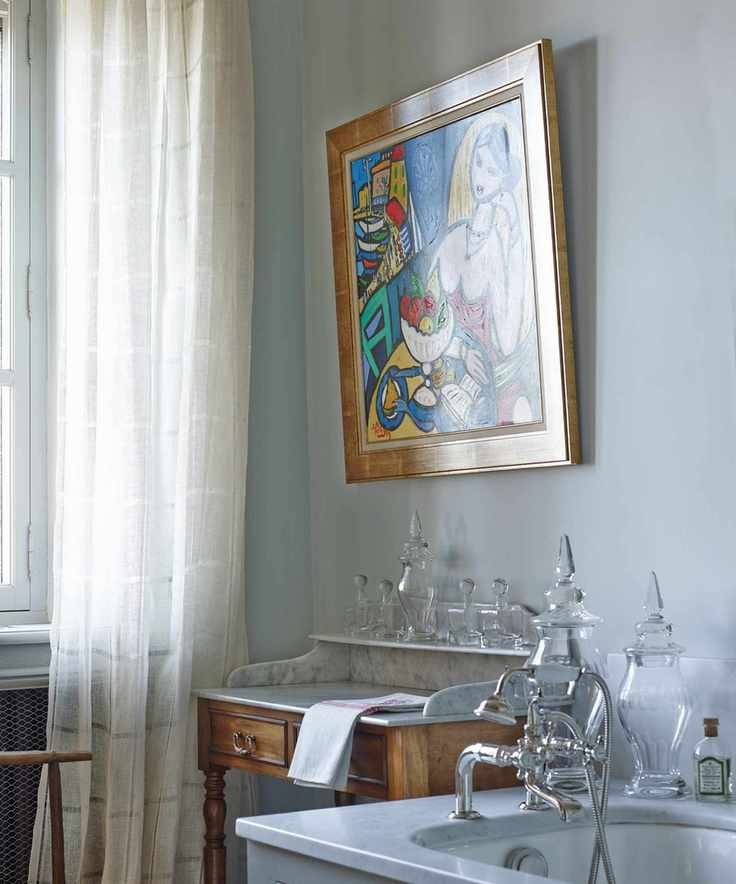 Vintage dressing table with colorful artwork above the sink