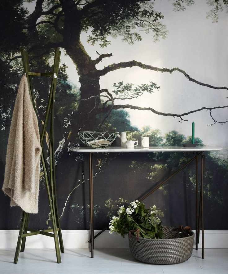 Hallway with a striking tree mural and a marble console table