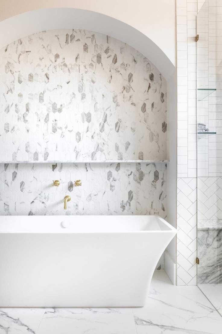 A white bathroom featuring various tile shapes