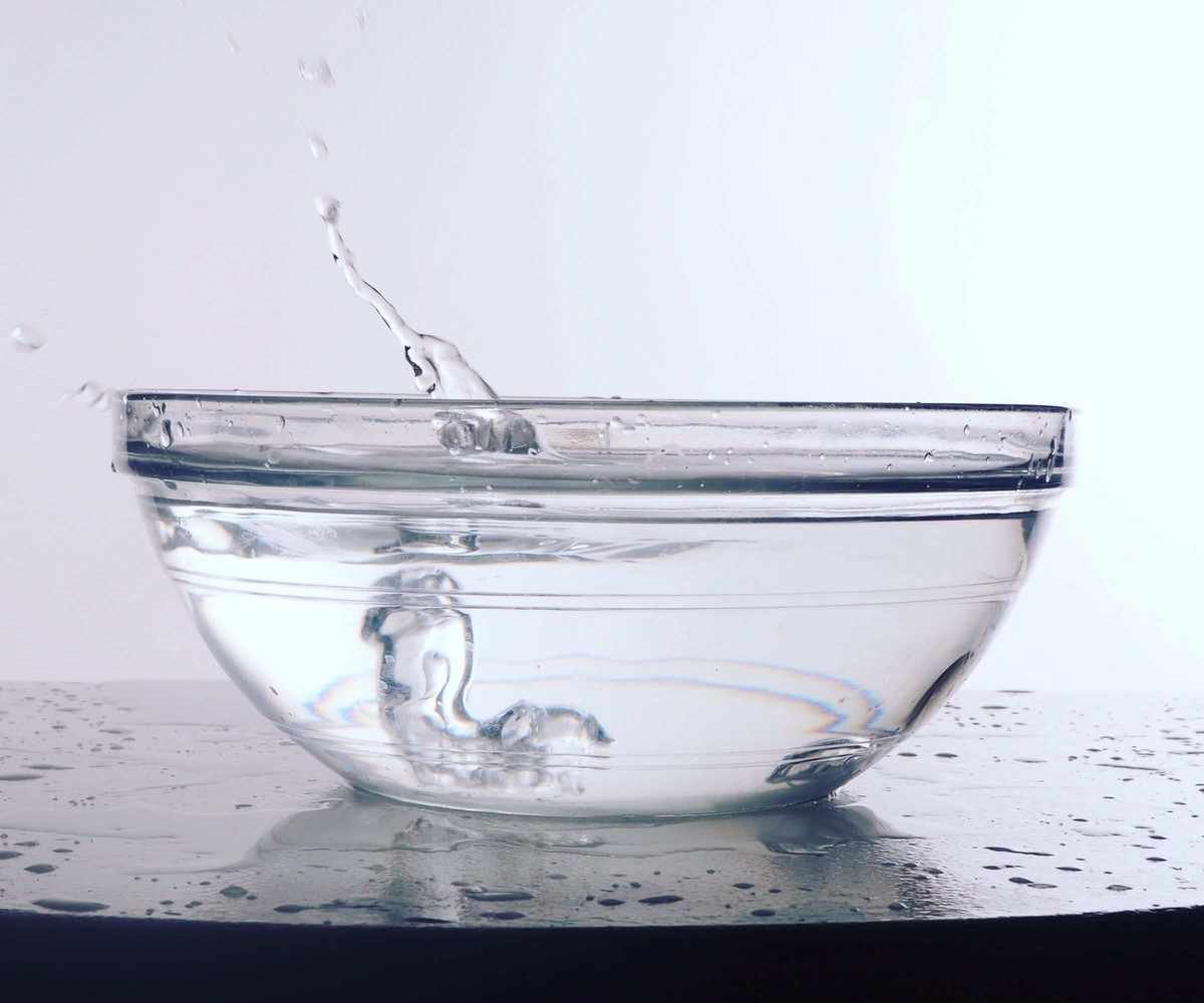 A small glass bowl of white vinegar