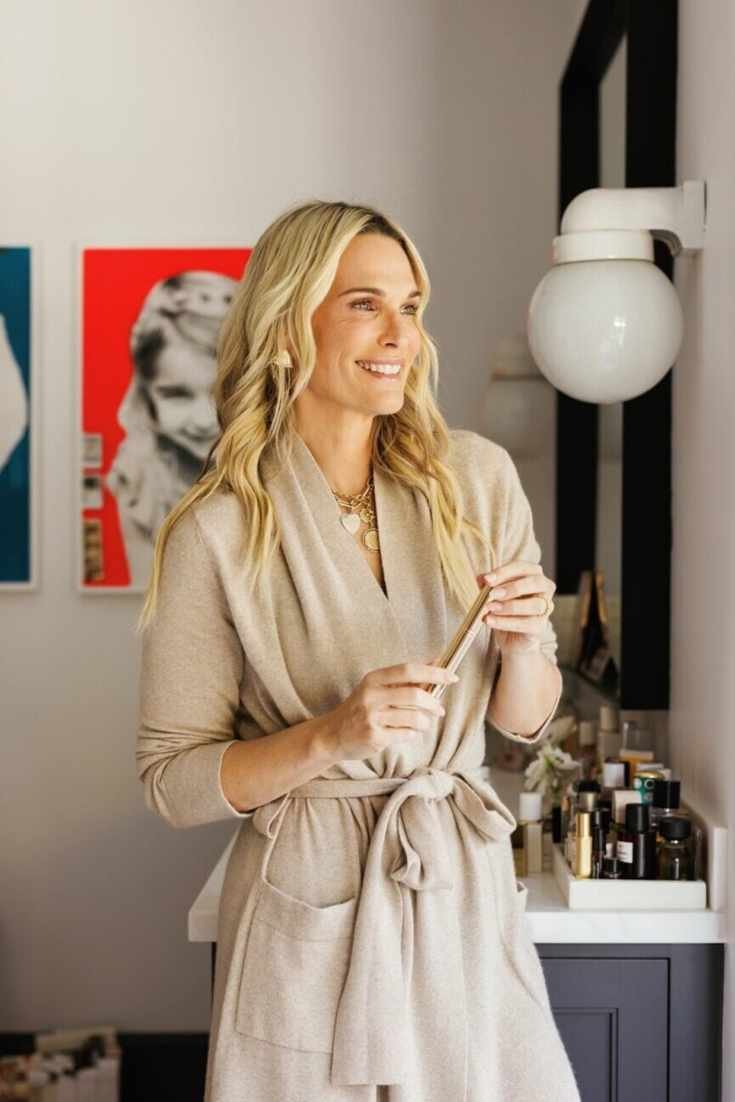 Molly Sims using skincare products.
