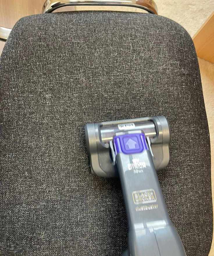 Furbuster vacuuming pet hair from a chair