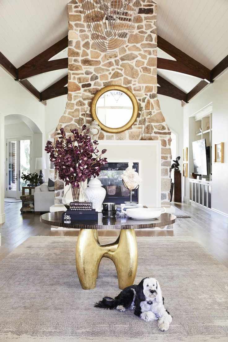 Farmhouse living room with exposed stone and a mirror