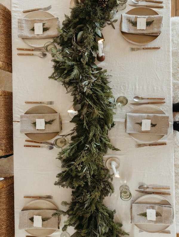 Holiday table with evergreen runner, casa zuma dinnerware