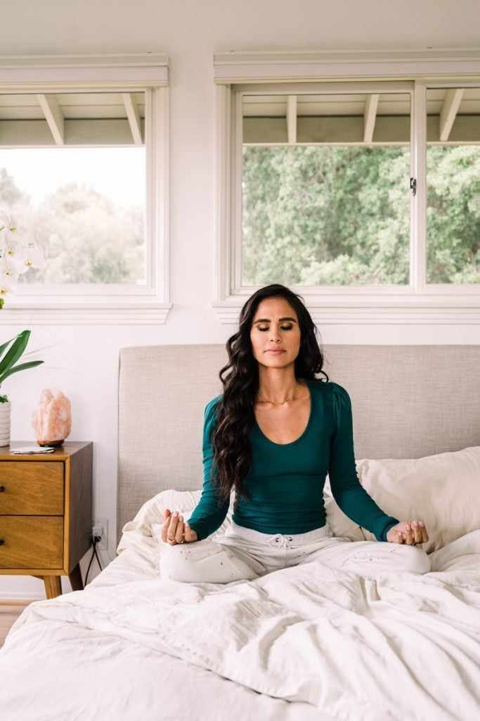 woman meditating in bed