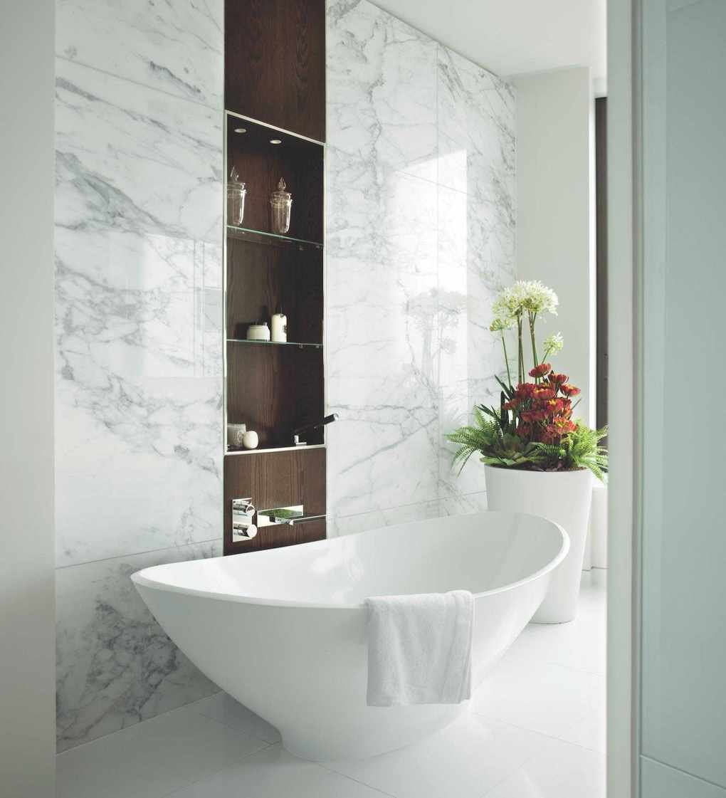 A marble bathroom with walnut shelving