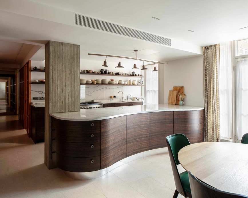 A single large room with a kitchen built around the supporting steel beam within the ceiling space