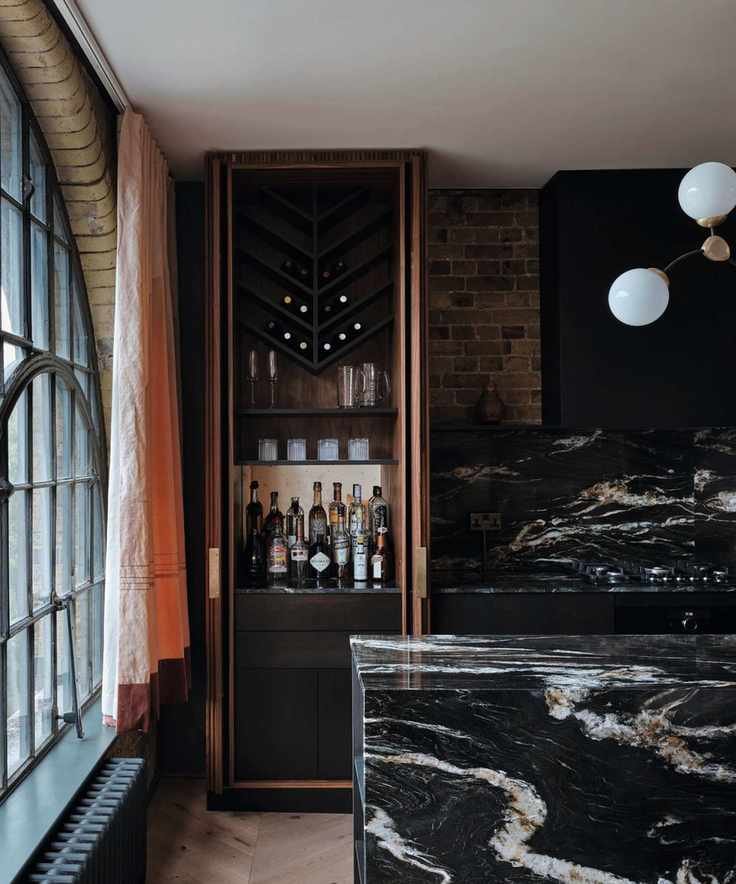 homebar in inbuilt cabinet with black marble kitchen