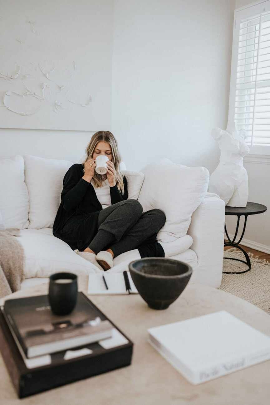 woman drinking tea on couch_living alone for the first time
