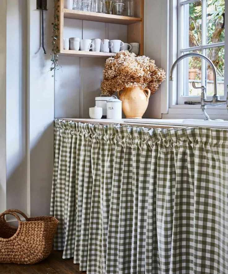 A gingham curtain under a kitchen sink.