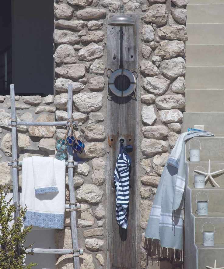 Outdoor shower on stone beach house