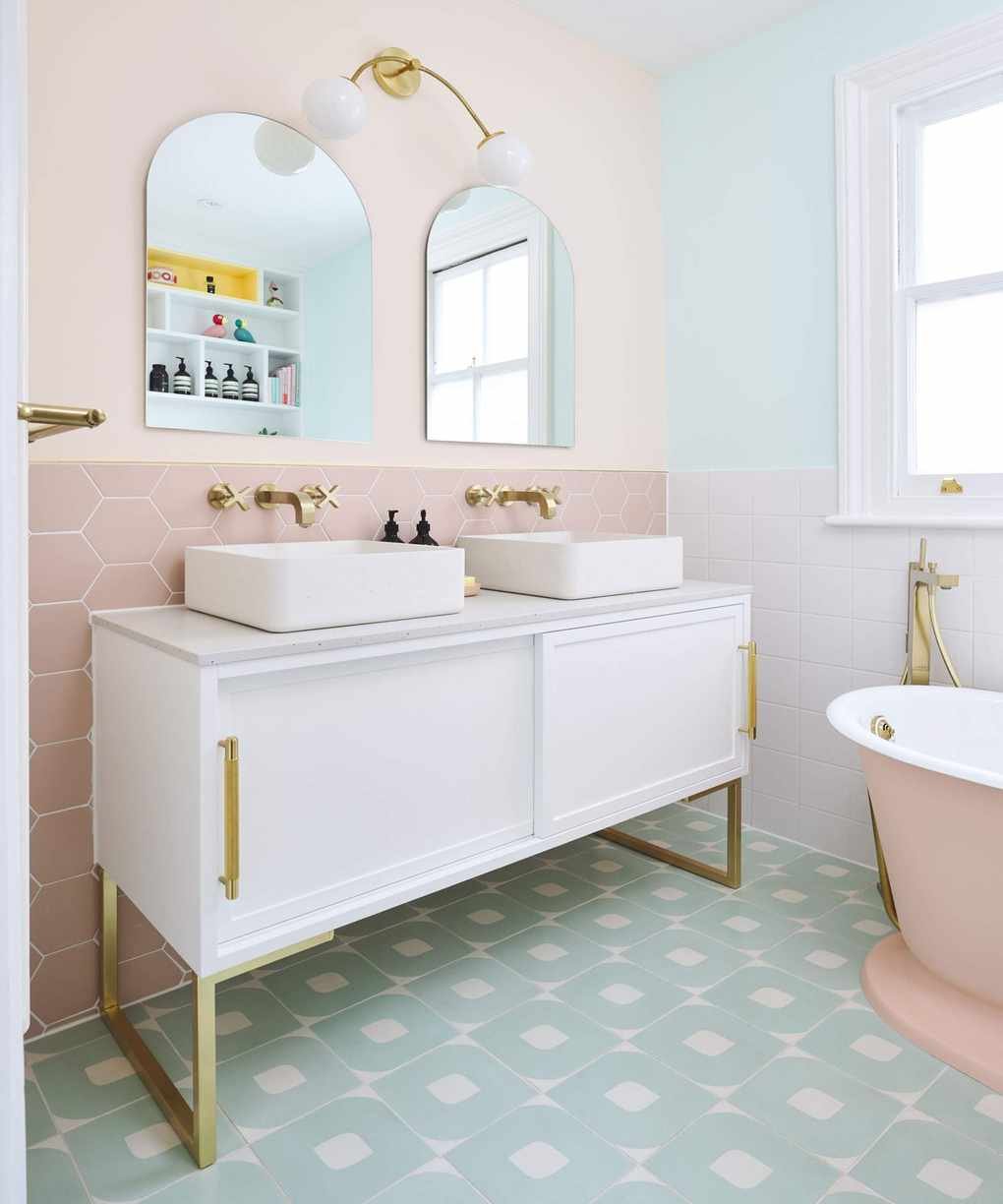 Pastel-themed bathroom with varied tile designs