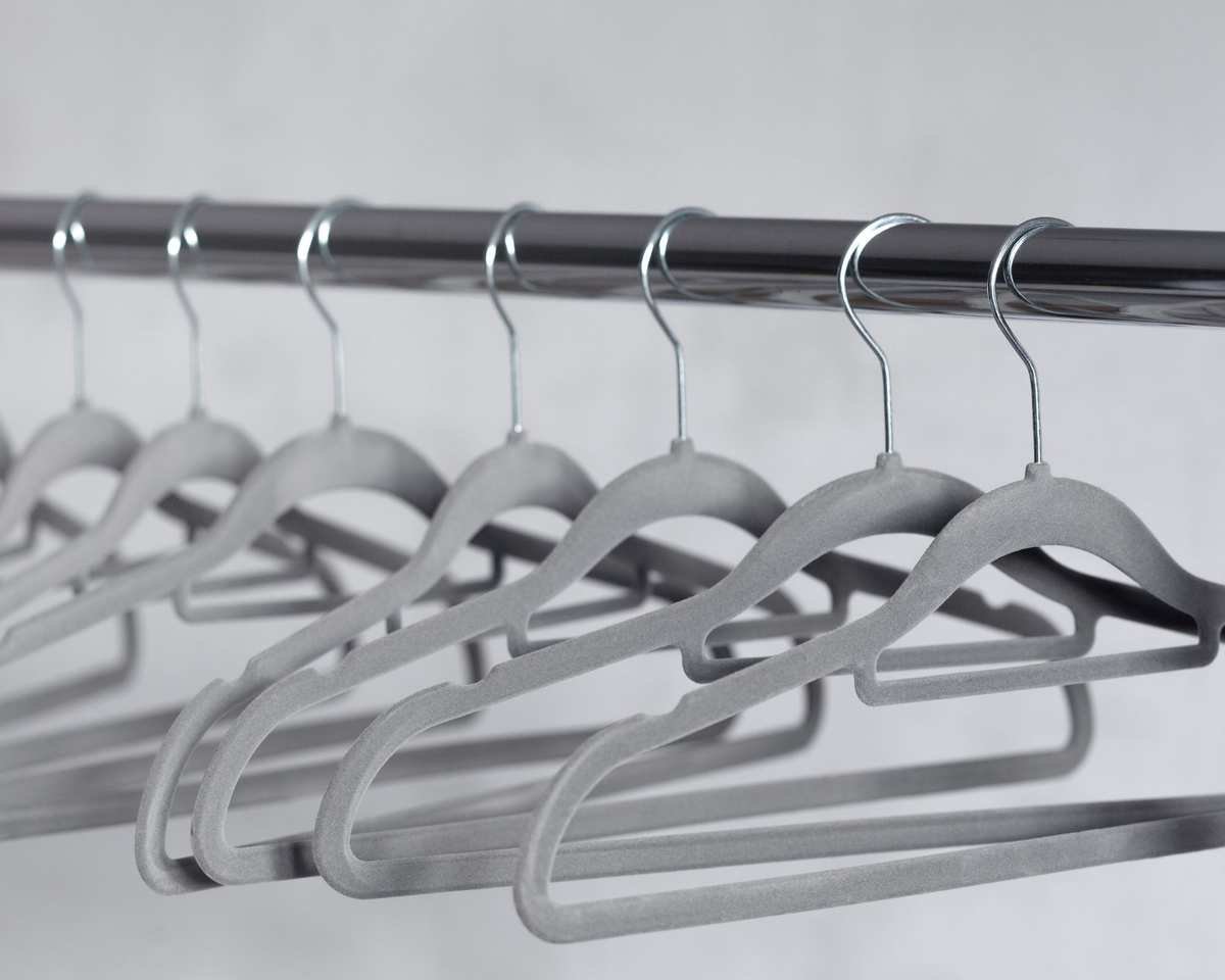 Gray velvet hangers on a rail