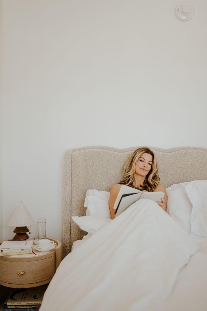 Woman journaling in bed.