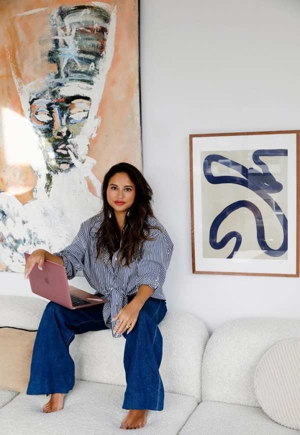 woman sitting on couch with laptop