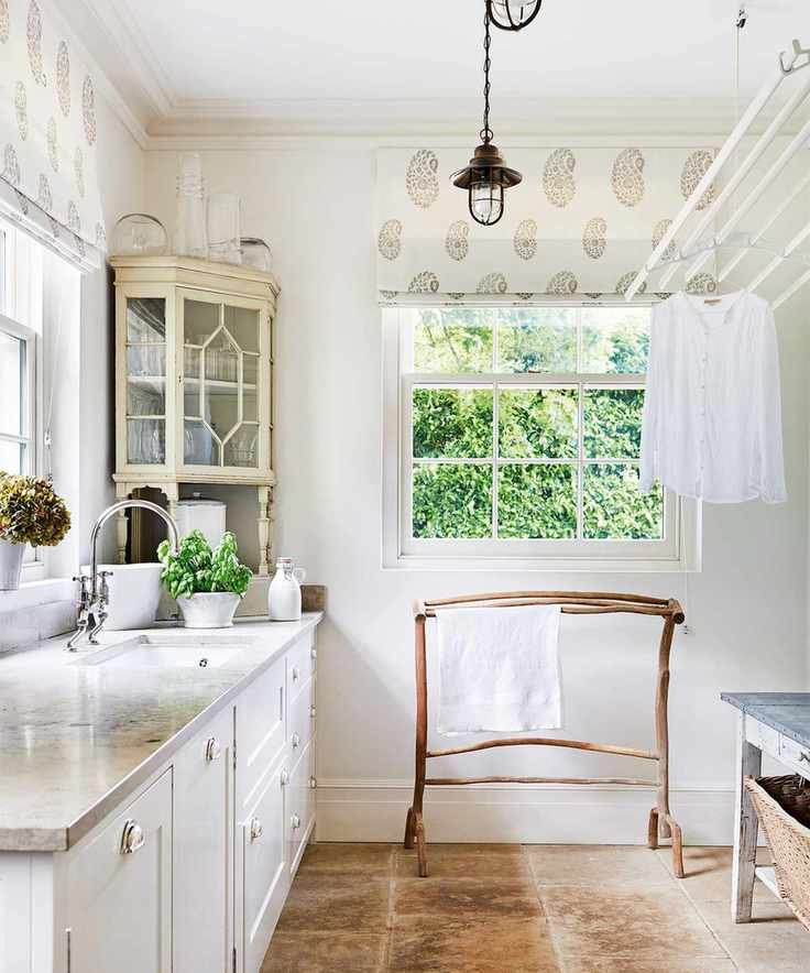 Laundry room with a pulley drying rack and wooden rail.