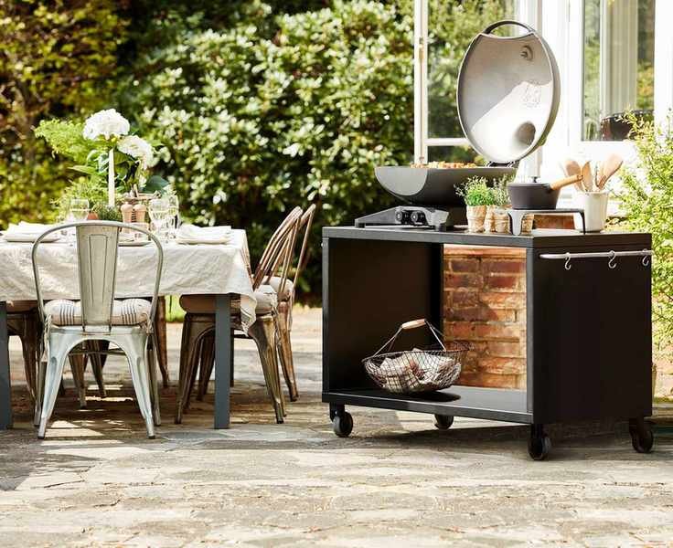 A modern outdoor kitchen setup with a fire feature for warmth and ambiance.