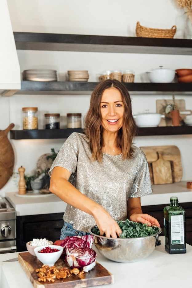 camille massaging kale in kitchen, meal prep