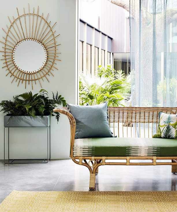 A tropical green living room picture with rattan furniture.