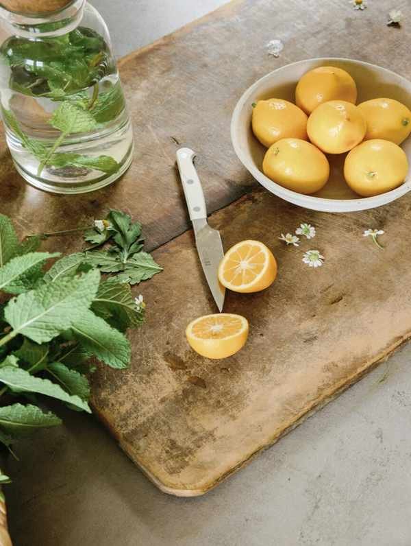 Slicing lemons on cutting board.