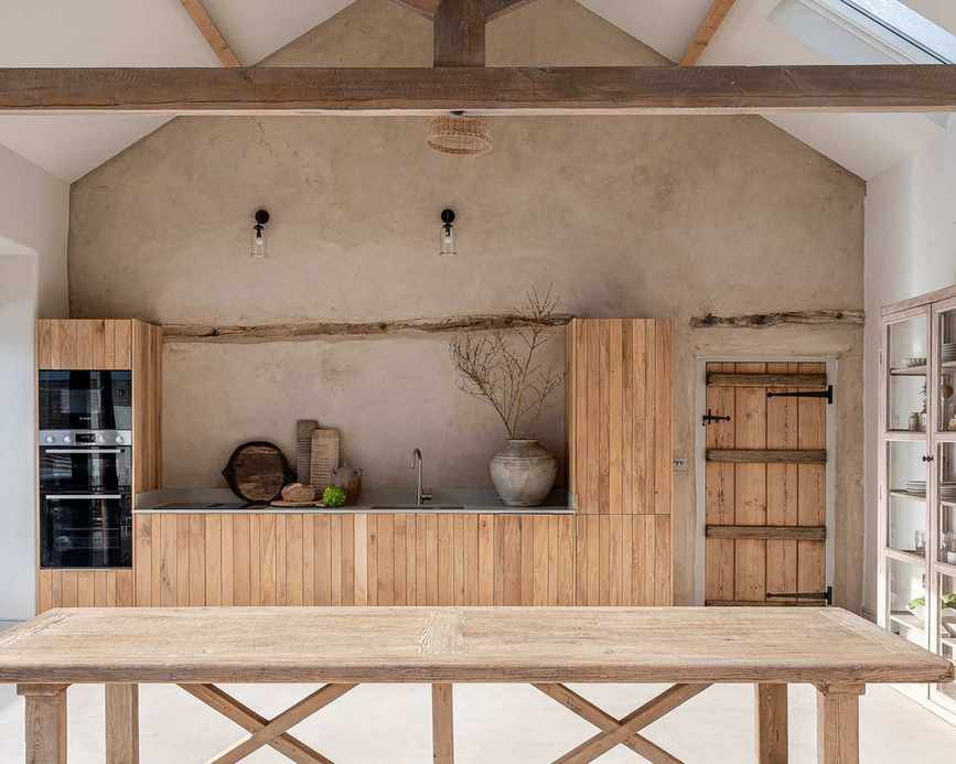 Galley kitchen with wood cabinets and plaster wall