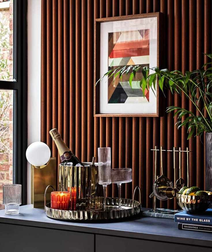 Gold barware on a sideboard including Habitat Japonica Cocktail Set