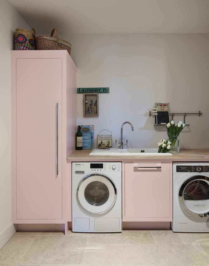 A pale pink utility room.