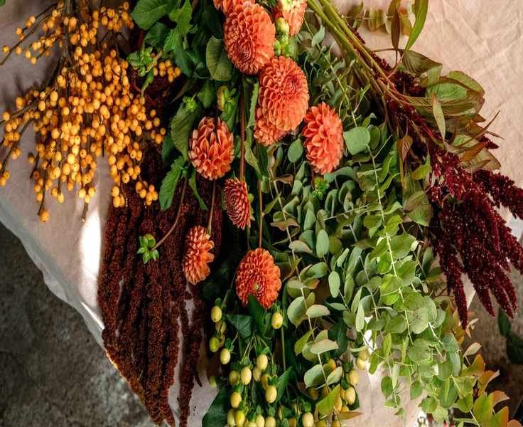View of dahlias, orange berries, burgundy amaranth, eucalyptus and cream hypericum