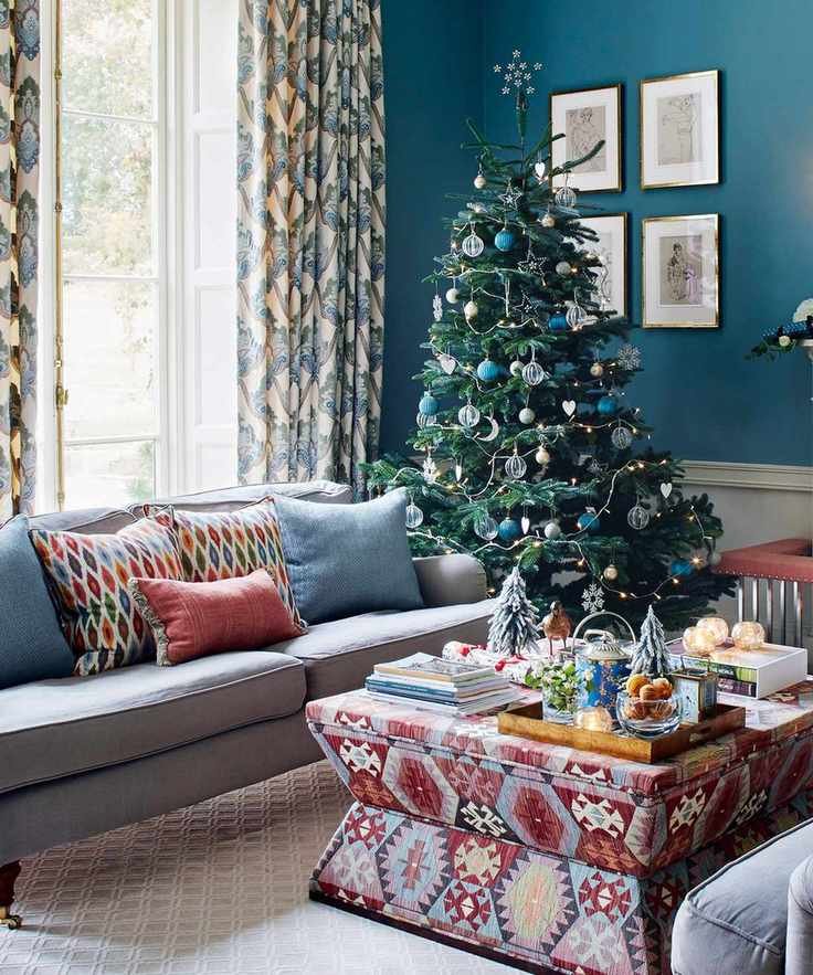 Blue living room with christmas tree and sofa