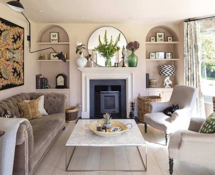 Neutral living room with a cozy velvet sofa and taupe chairs.
