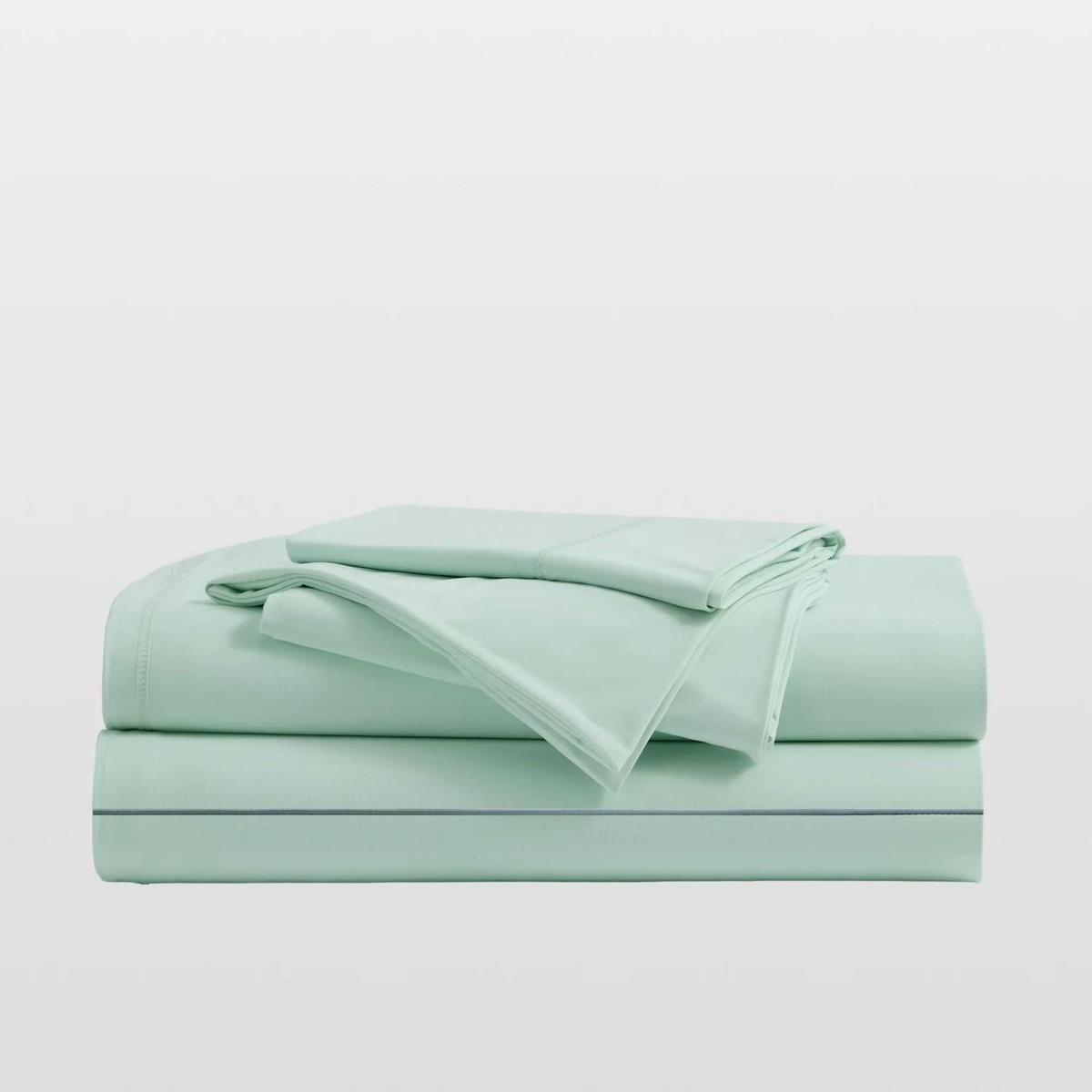 Mint green Breescape cooling sheets folded up in a pile