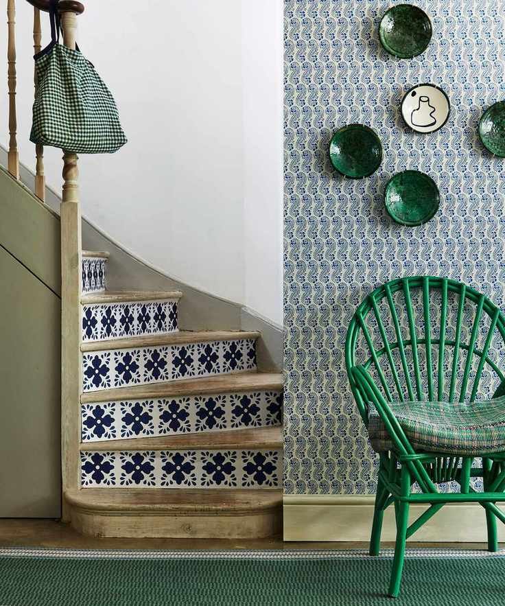 Hallway featuring a green wicker chair and Mediterranean tile wallpaper