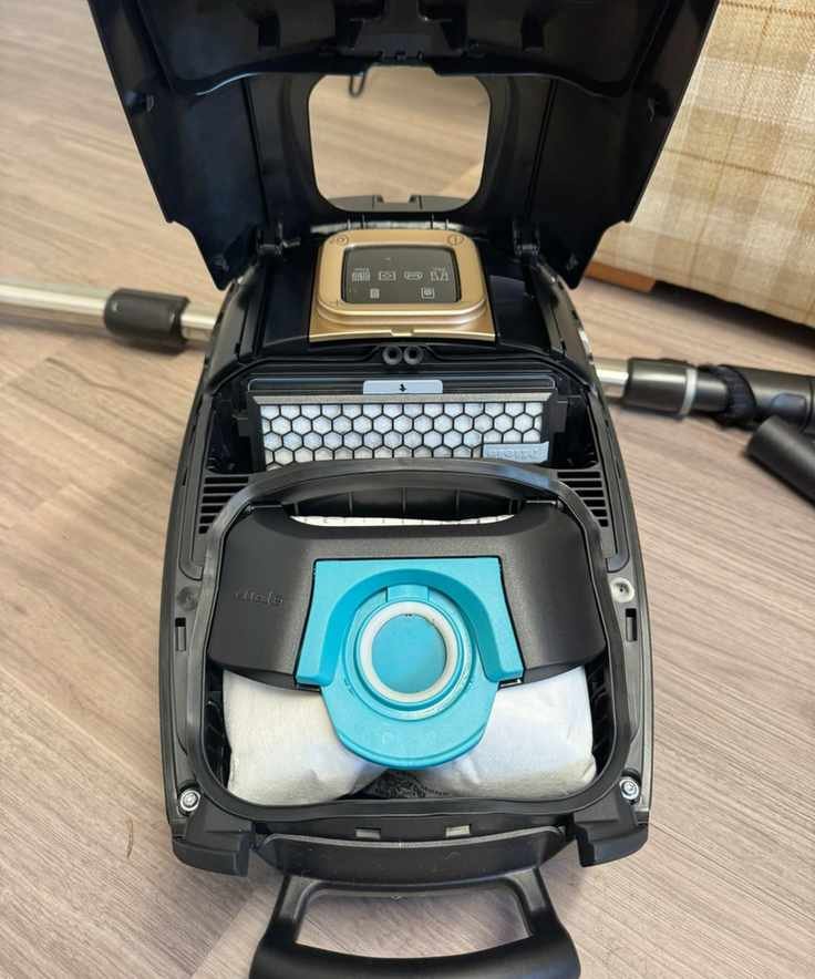 Inside the Miele Guard L1 Cat and Dog canister vacuum, showing vacuum bag and air filter.