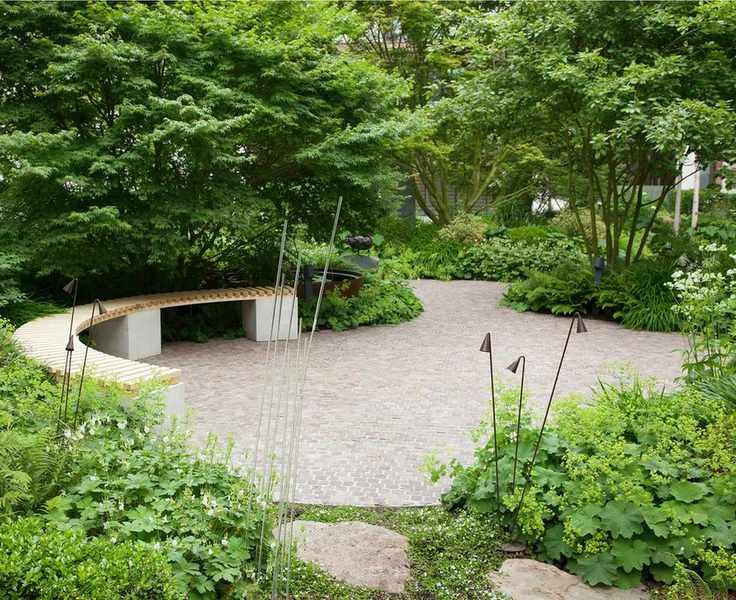 Complex patio design featuring curves and greenery.