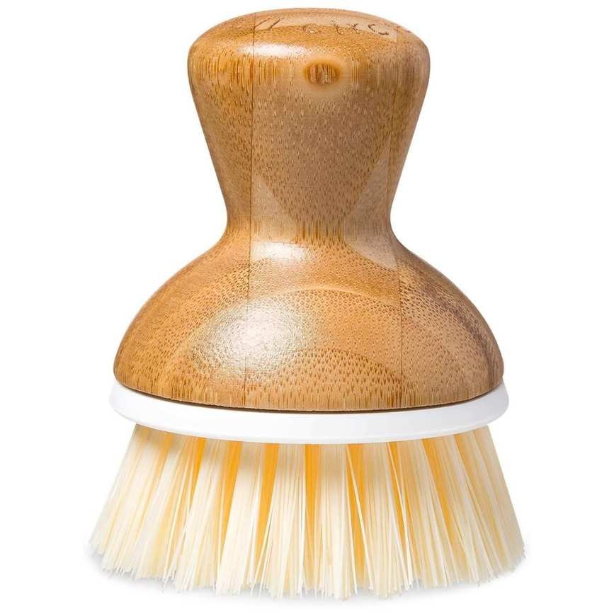 A wooden circular scrubbing brush