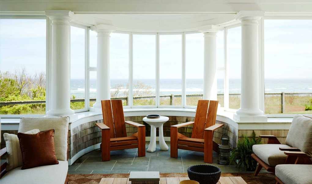 Front porch with columns, adirondack chairs and coffee table