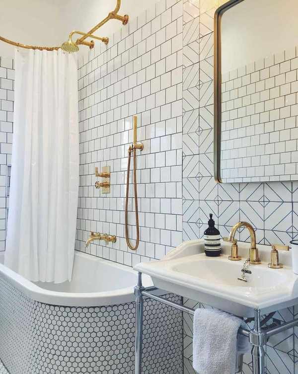 A bathroom featuring a curved bath with geometric and mosaic tiles