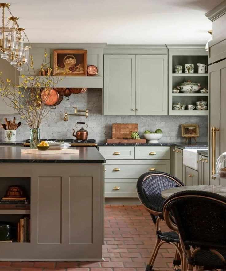 Cozy cottage kitchen with pale green kitchen cabinetry and terracotta floor