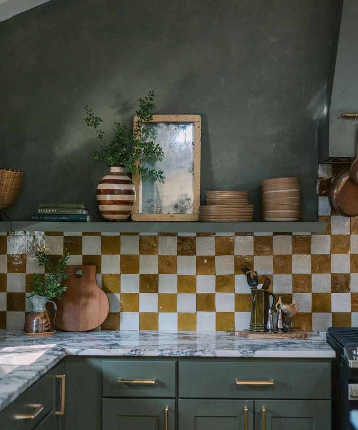A rustic kitchen showcasing dark green walls and cabinetry.