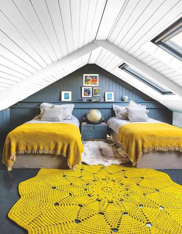 twin bedroom with dark blue walls and ochre covers and rug