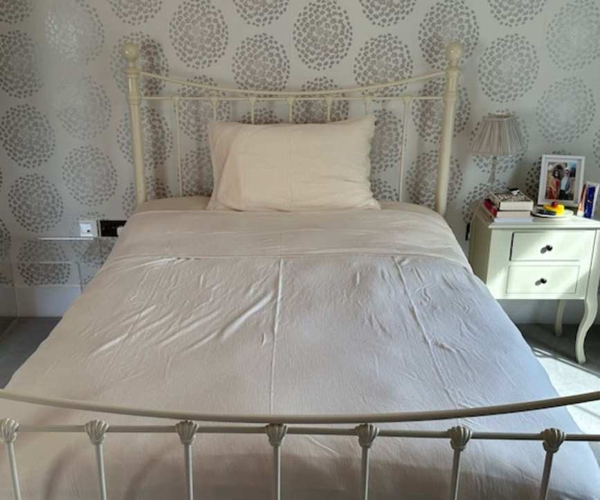 Cozy Earth Silk Pillow on a bed.