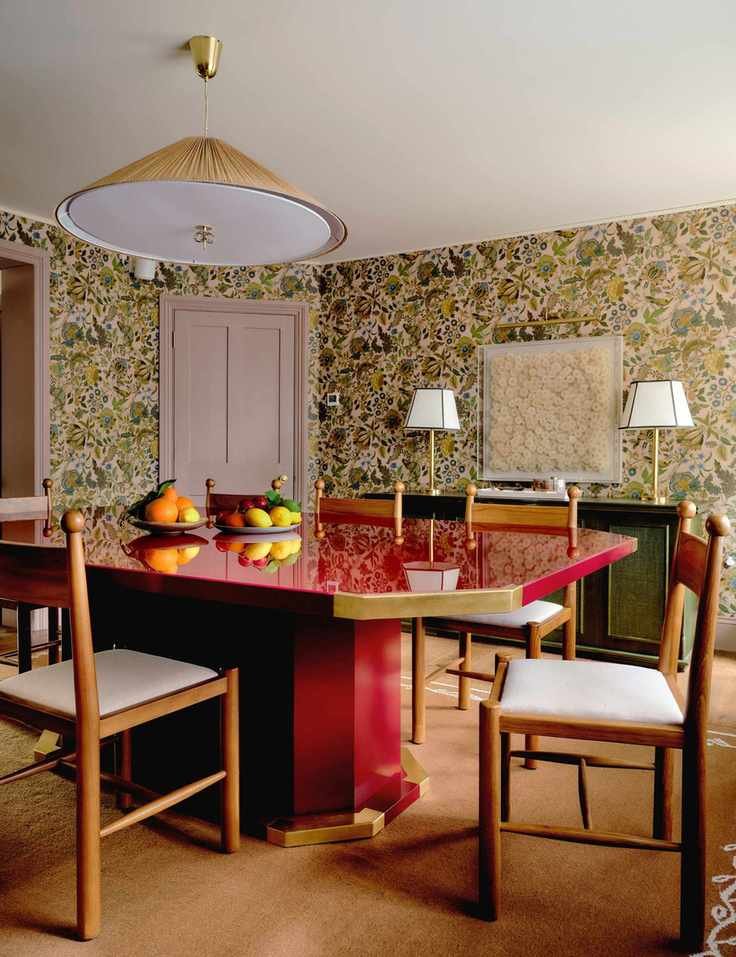 Dining room featuring a bright red lacquered dining table, a wool rug, and linen upholstered wooden dining chairs