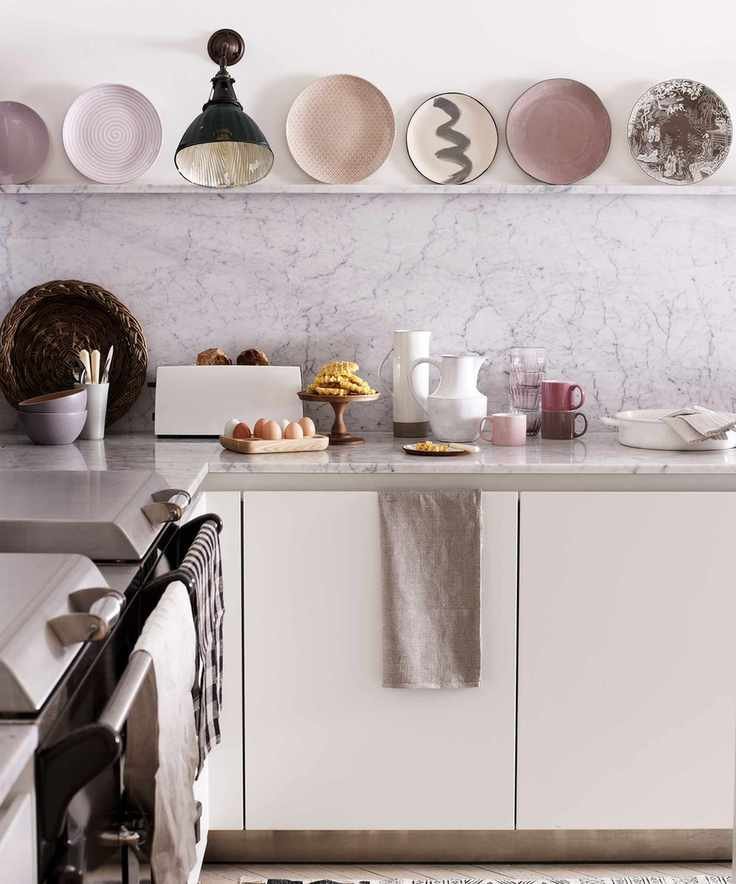 Kitchen wall lighting ideas with black wall downlight in a white kitchen with pastel pink accents.