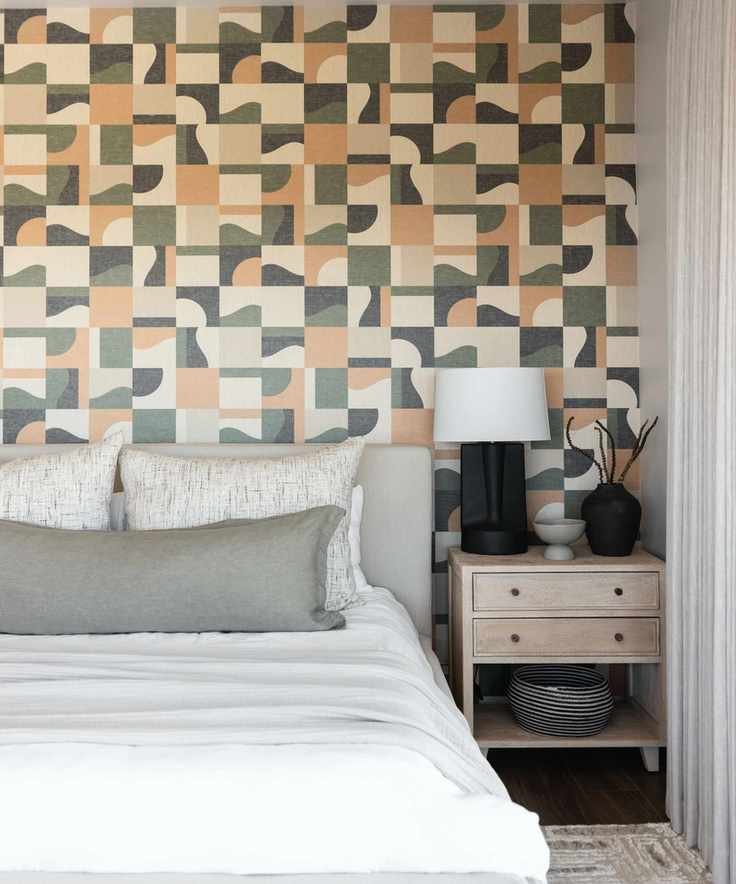 bedroom with retro graphic wallpaper and white bed linen